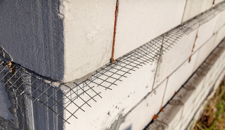 Metal mesh between the bricks in the concrete .の写真素材