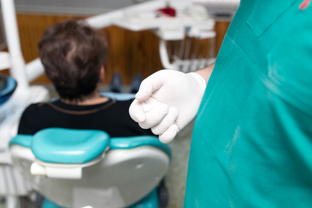 A dentist prepares an implant in the clinic .の写真素材
