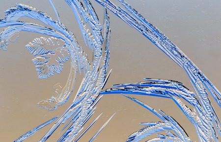 Snow patterns on glass as an abstract background .