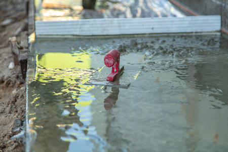 Workers pour concrete solution at a construction site .の写真素材
