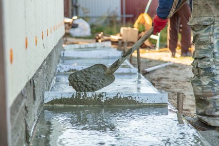 Workers pour concrete solution at a construction site .の写真素材
