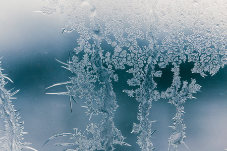 Snow patterns on glass as an abstract background .