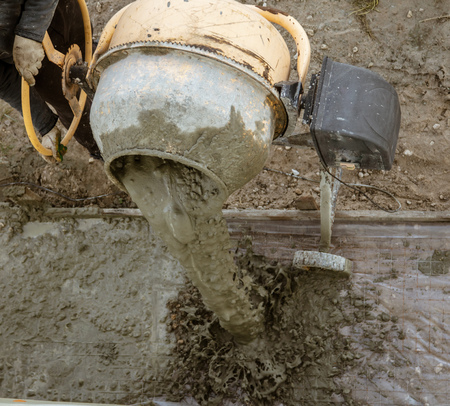 Workers pour concrete solution at a construction site .の写真素材