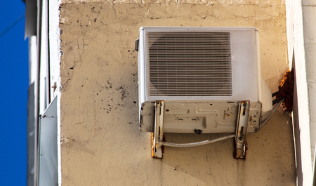 Air conditioner hanging on the wall of the building .の写真素材