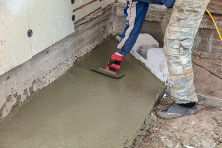 Workers pour concrete solution at a construction site .の写真素材
