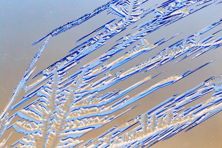 Snow patterns on glass as an abstract background .
