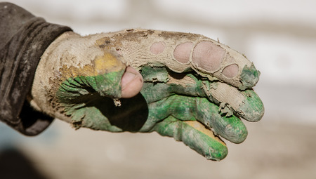 The glove on the hand of the builder .