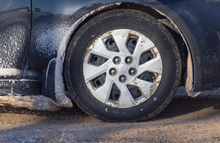 Car wheel in the snow in winter .の写真素材