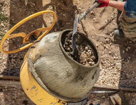 Workers pour concrete solution at a construction site .の写真素材