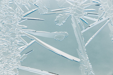 Snow patterns on glass as an abstract background .