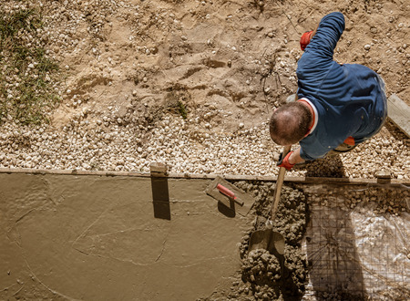 Workers pour concrete solution at a construction site .の写真素材