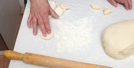 Cooking dough on the table at home .