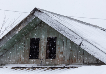 Snow on the roof of the house as a background .の写真素材