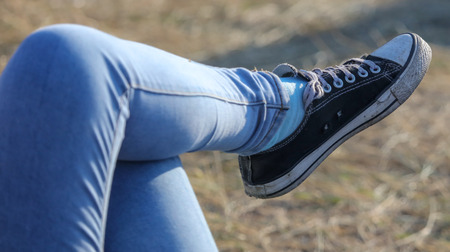 Sneakers on the foot men in nature .の写真素材