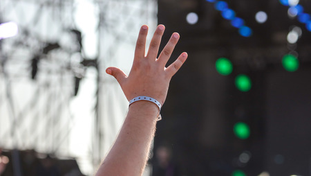 Hand raised up at a man at a concert .の写真素材