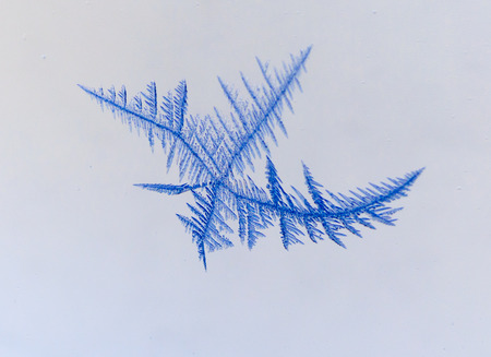 Snow patterns on glass as an abstract background .