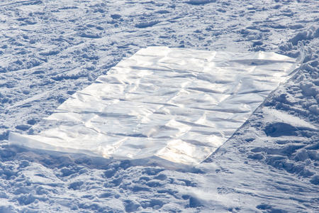 Polyethylene on white snow as a background.