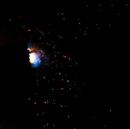 Flame of fire and sparks from welding metal at night .の写真素材