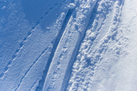 Traces of skiers on white snow in the mountains .の写真素材