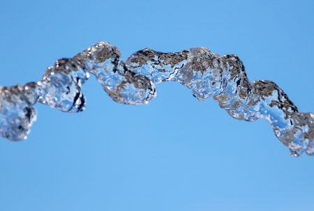 Splashes of water against the blue sky .の写真素材