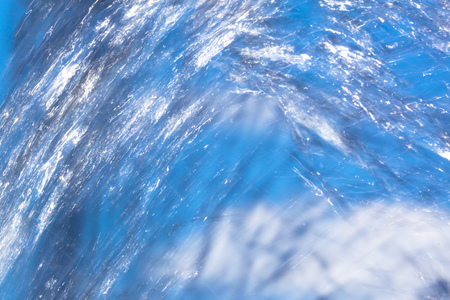 Splashes of water in motion as an abstract background.の写真素材