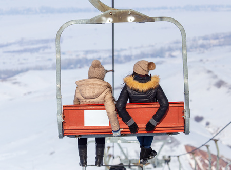 Ski lift and snowboarders in the mountainsの写真素材