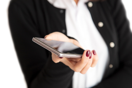 Phone in hand of a girl on a white background .の写真素材