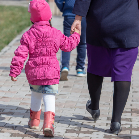 Mom holds her hand in the park .の写真素材