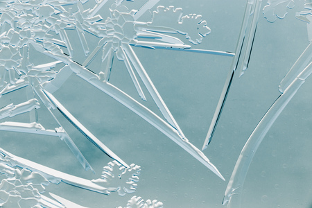 Snow patterns on glass as an abstract background .