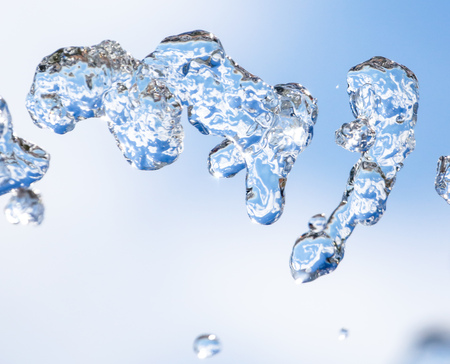 Splashes of water against the blue sky .