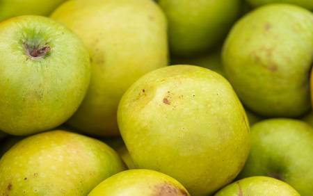 Green apples in the market as background .の写真素材