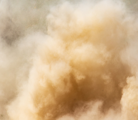 A cloud of dust from cars on nature as a backgroundの写真素材
