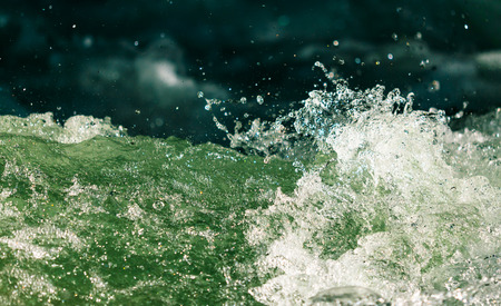 Splashes of water from the waves in the sea .