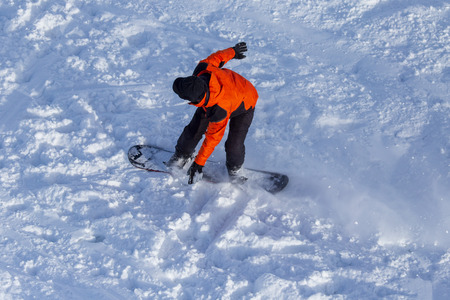 A man snowboarding a mountain in the snow in winter .の写真素材