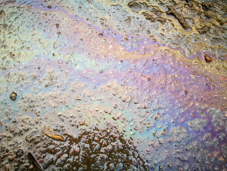 Gasoline spilled on the ground as an abstract background.の写真素材