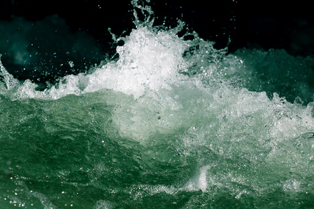 Splashes of water from the waves in the sea .