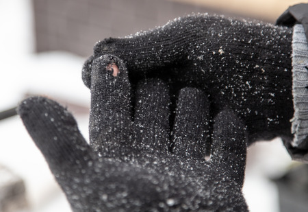 Man puts gloves on his hands in winter .の写真素材