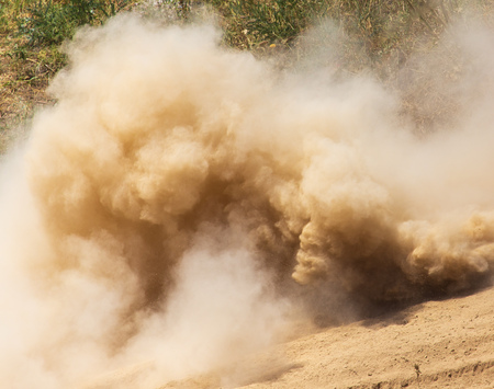 A cloud of dust from cars on nature as a backgroundの写真素材