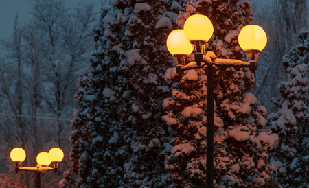 Lanterns burning on a pole at night in the park .の写真素材