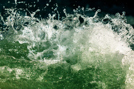 Splashes of water from the waves in the sea .