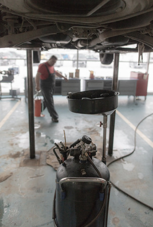 Changing the oil in the car box in the workshop .の写真素材