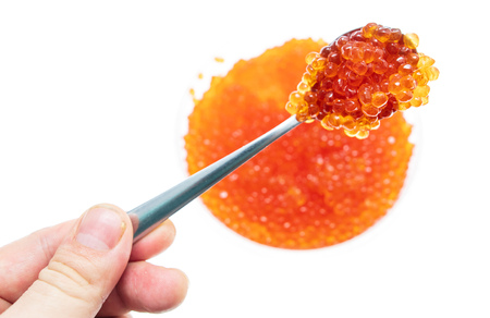 Spoon in red caviar on a white background .の写真素材