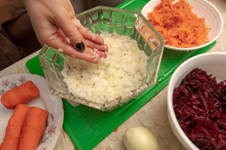 Cooking herring under a fur coat in the kitchen .の写真素材