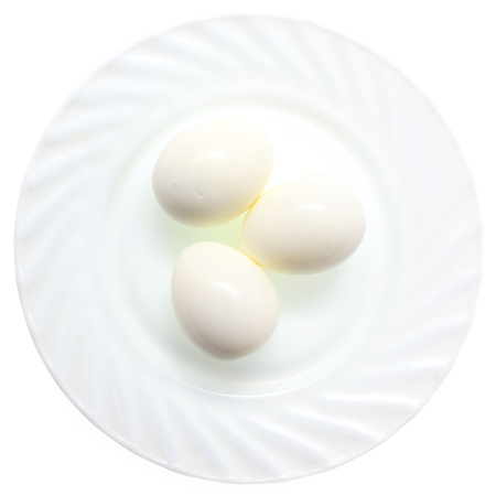 Peeled boiled eggs in a plate on a white background .の写真素材