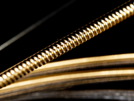 Strings for guitar on a black background. Macro