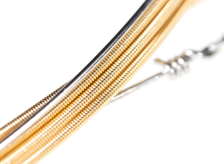 Strings for guitar isolated on a white background. Macro