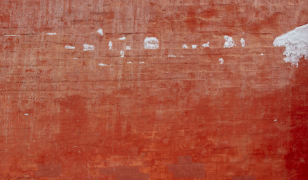 Snow on a red brick wall as background.