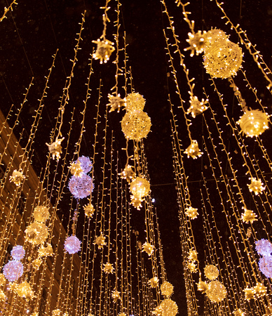 Bulbs glow on the city street at night .