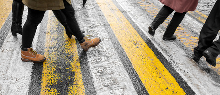 Feet of people at a pedestrian crossing in winter .の写真素材