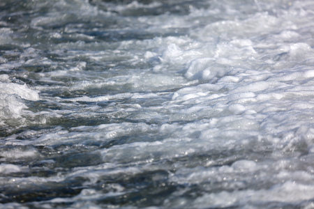 Waves on the seashore as an abstract background .